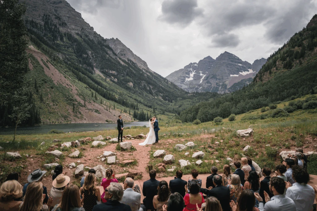 Event guests gathered on a lodge patio in Aspen as evening alpenglow lights the peaks