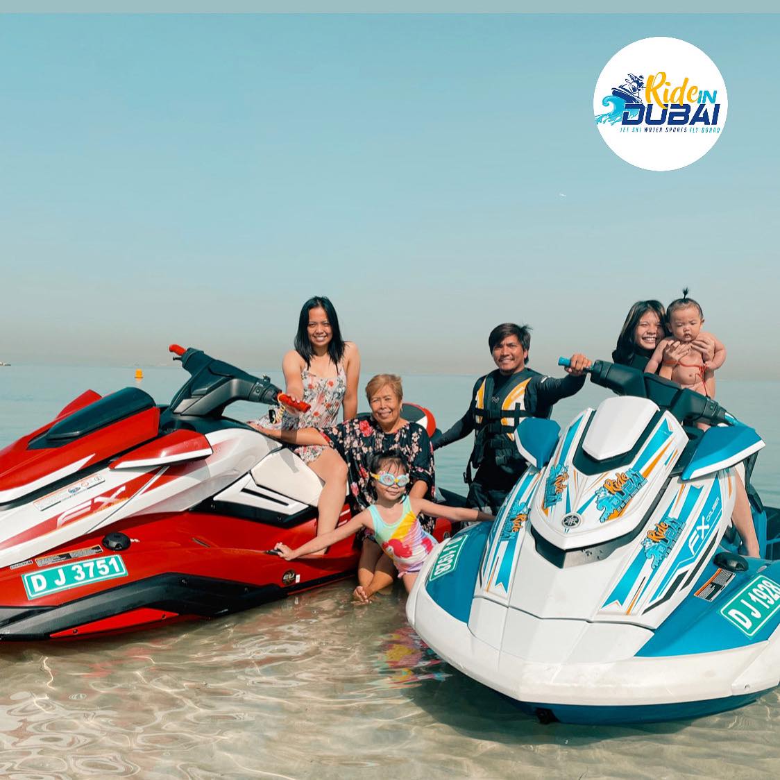 A happy family poses with their jet ski rental