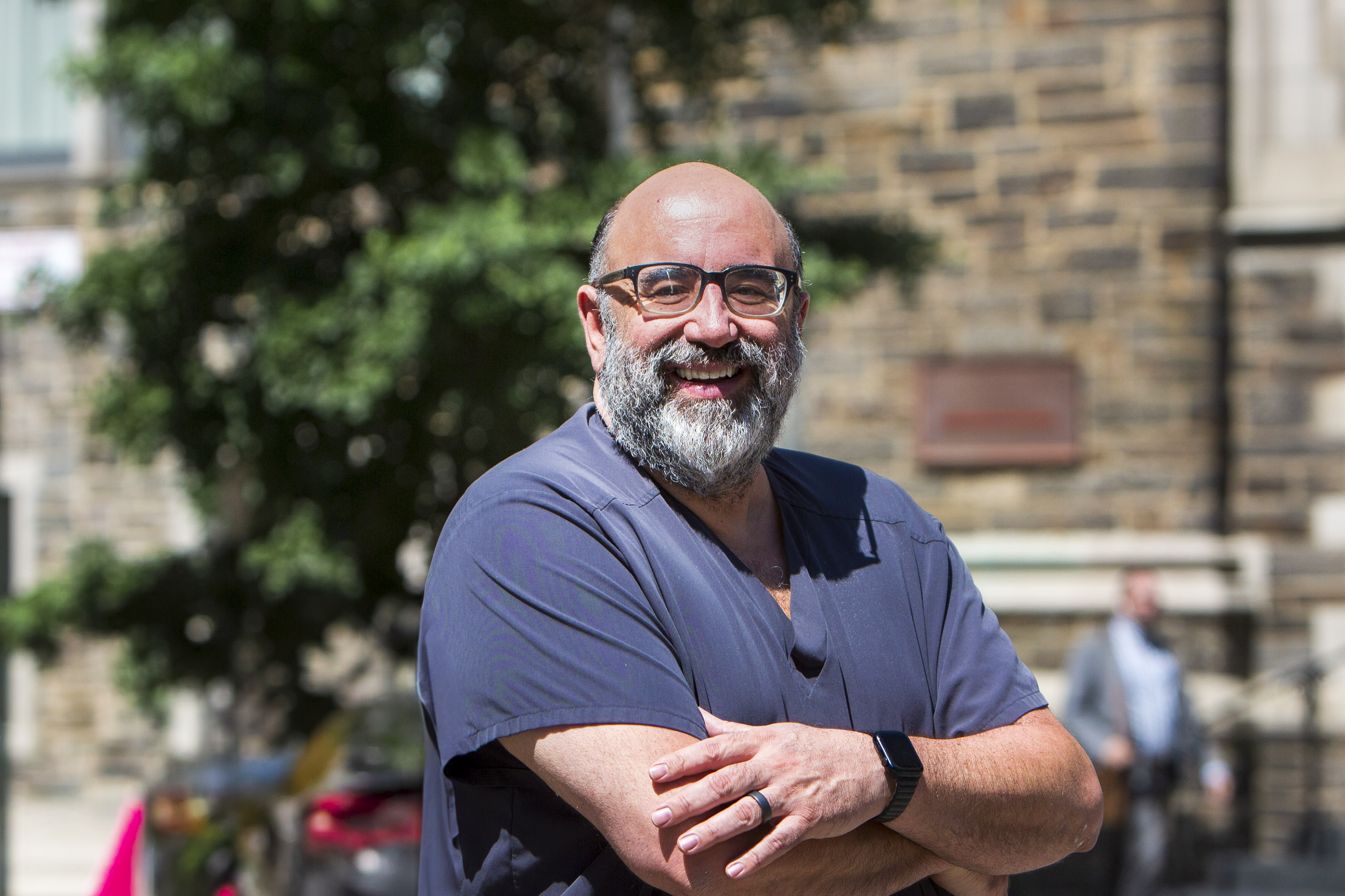 Portrait of a woman with long red hair gently touching her face, looking into the camera