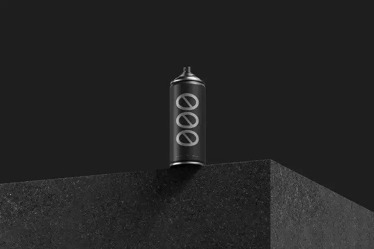Matte black spray can mockup displayed on a textured black pedestal against a dark background. The minimalist design and lighting emphasize a sleek, modern aesthetic.