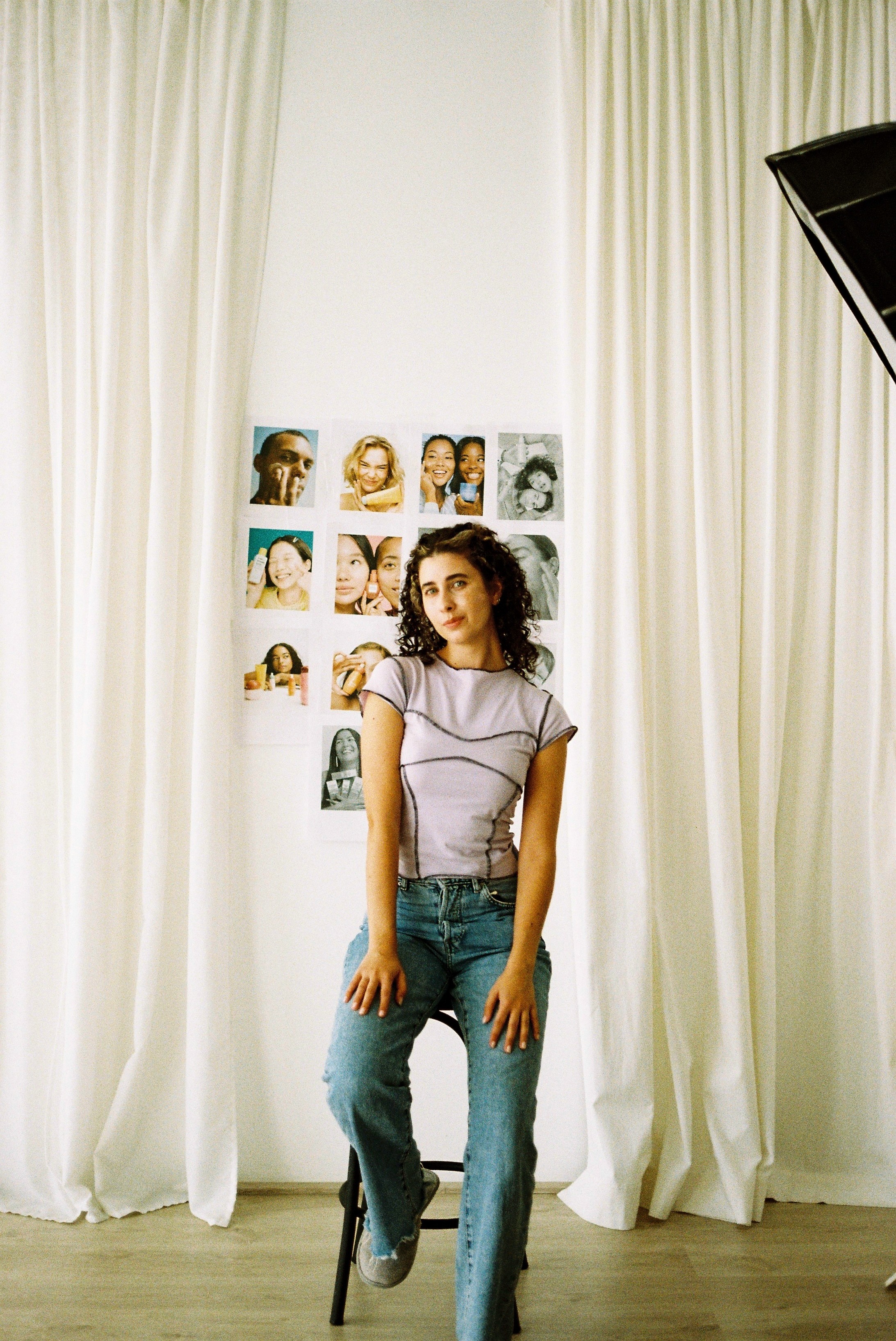 Portrait of Jake Carter, a young man with short dark hair wearing a white shirt and earphones, looking slightly upward against a neutral background.