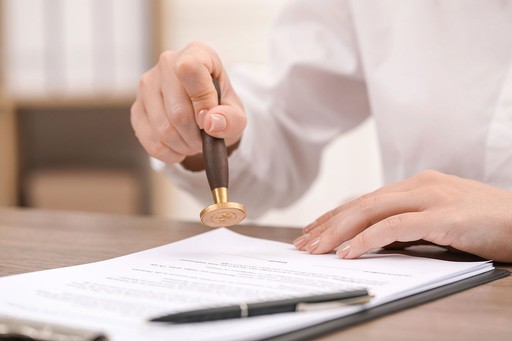 a person stamping a document, illustrating the apostille