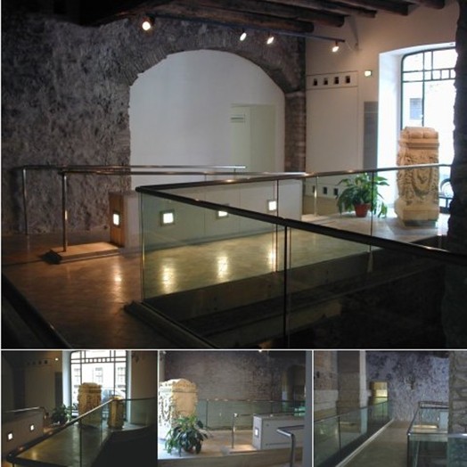 A group of photos in a museum and a carved stone on display.