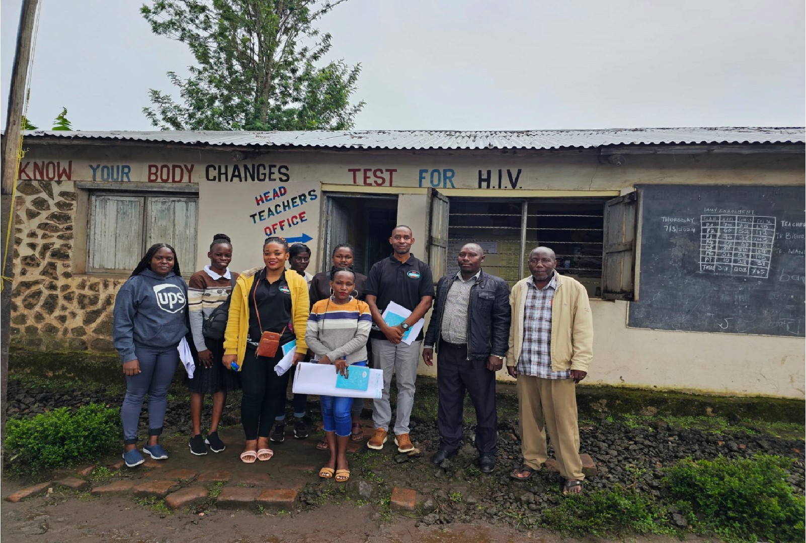 man in black crew neck t-shirt and blue shorts holding woman in white and red