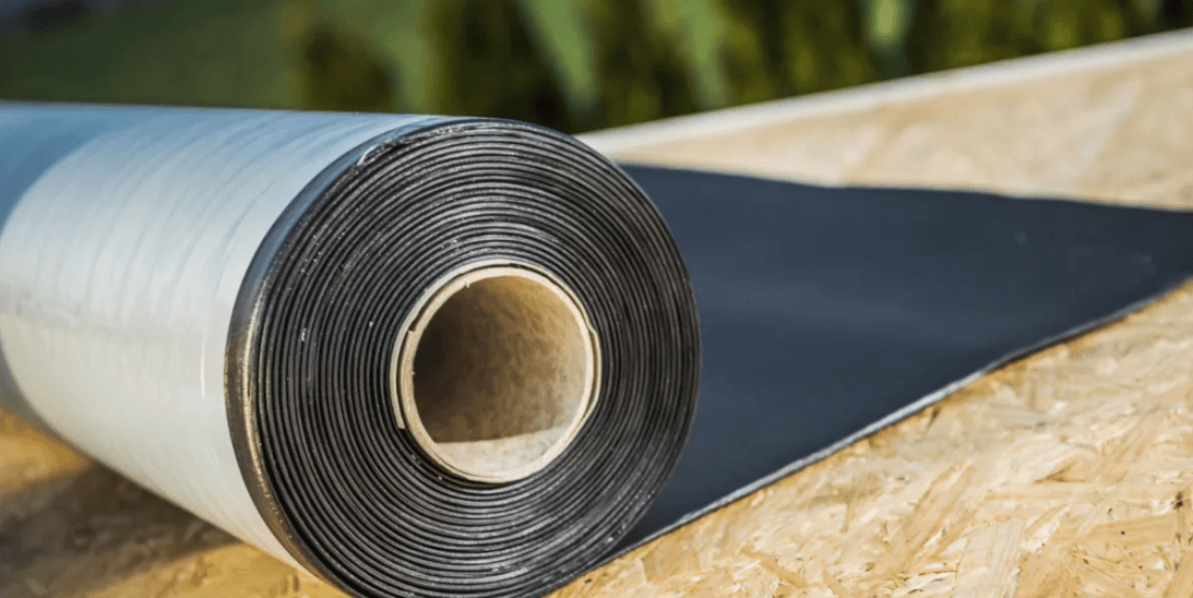 a man in a yellow shirt is working on a roof