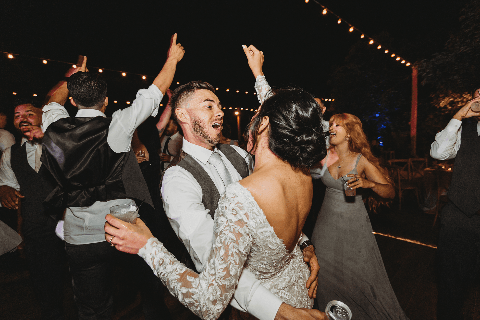 Flat lay wedding details with bouquet, rings, and sparkling bridal heels