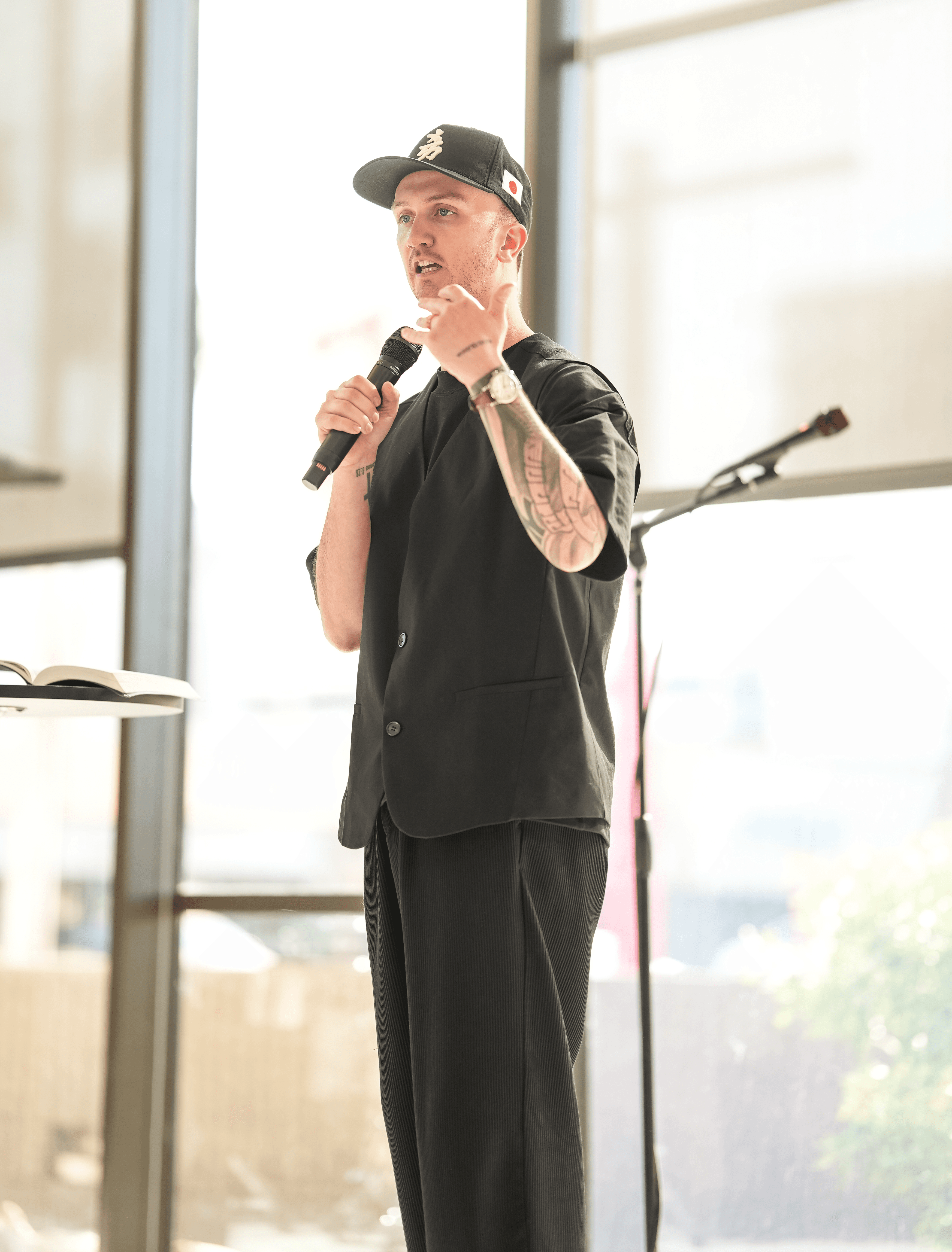 Josh Andrew preaching on stage about church leadership, culture, and discipleship