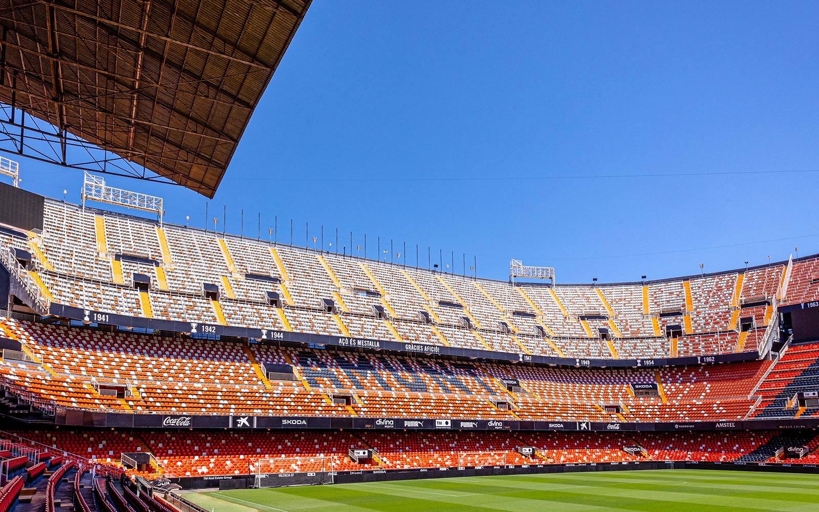 Mestalla Stadium seating and field under clear blue sky in Valencia.