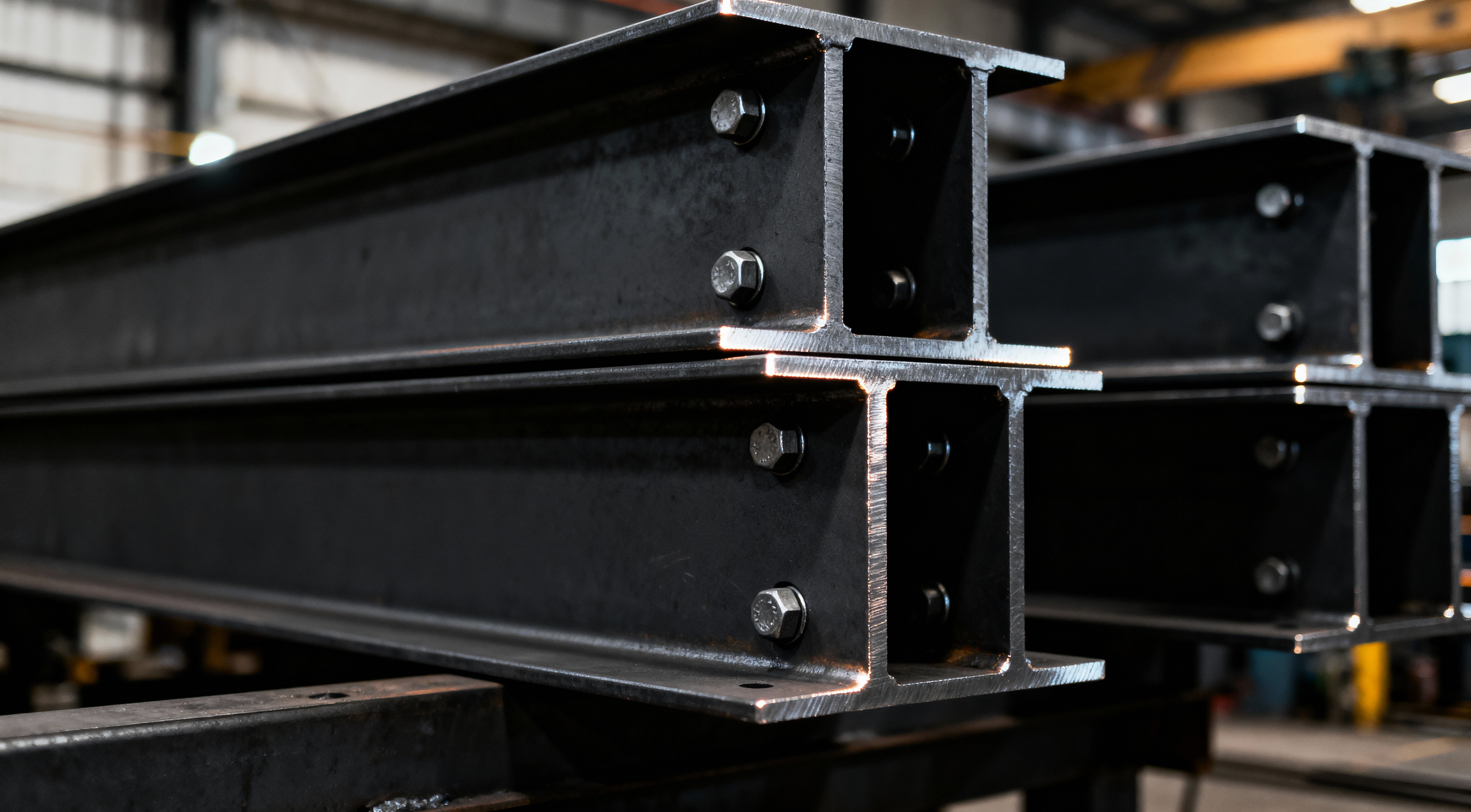 Structural steel beams in workshop — Iron & Crane providing custom fabrication and precision metalwork for industrial projects.