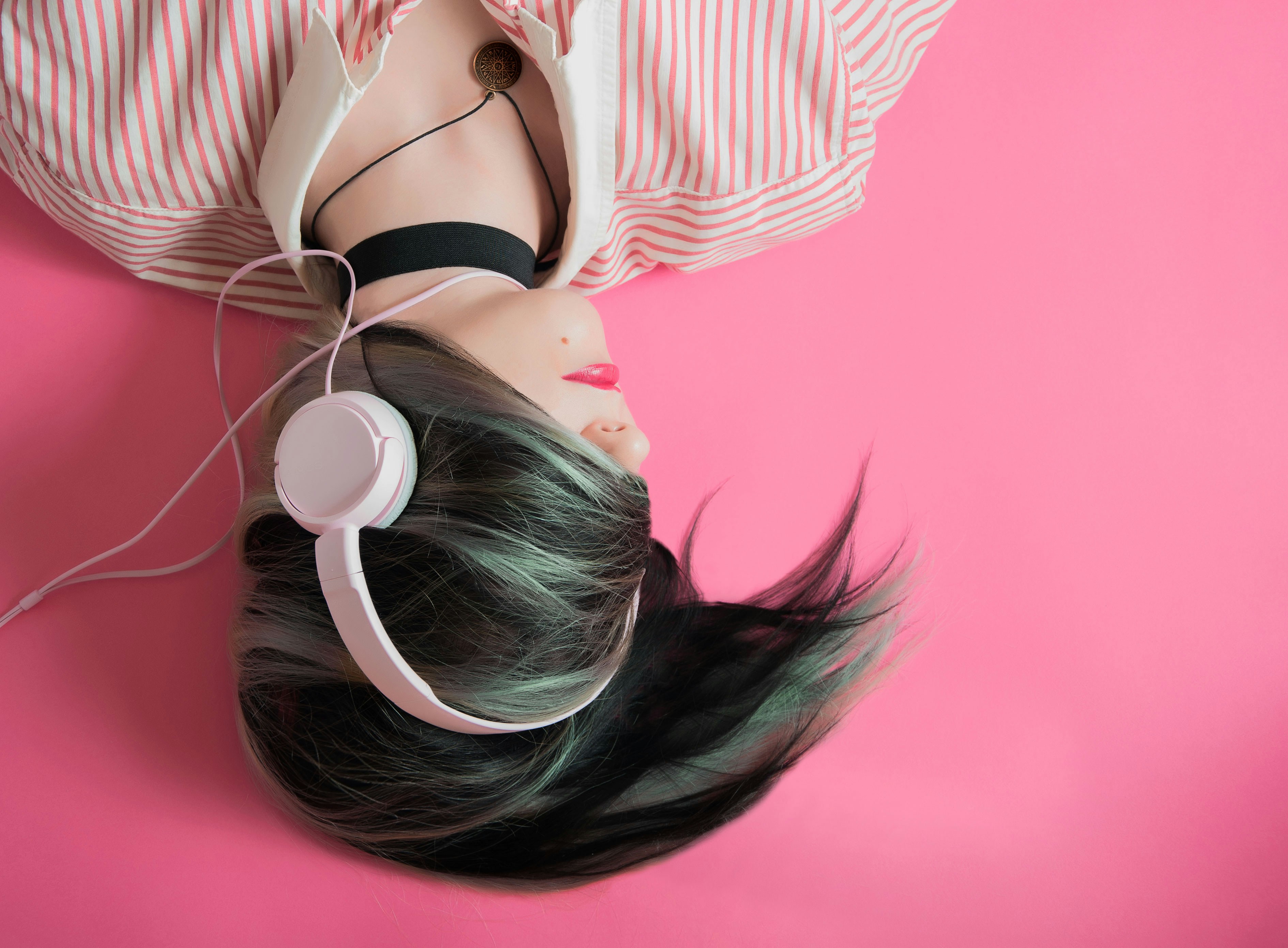 Girl Laying while wearing Headphones - How To Mix Songs 