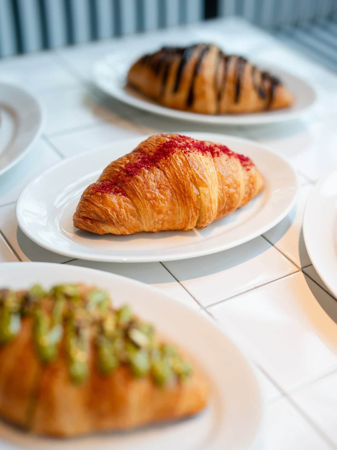 Freshly baked buttery flaky croissant at Mandy's Bakery, a must-try for brunch in Downtown Dubai at Social Distrikt food hall.