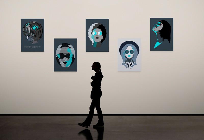 A woman walking past the monochrome artwork