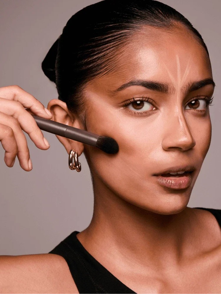 Two toddlers in puffy jackets playing in the snow.