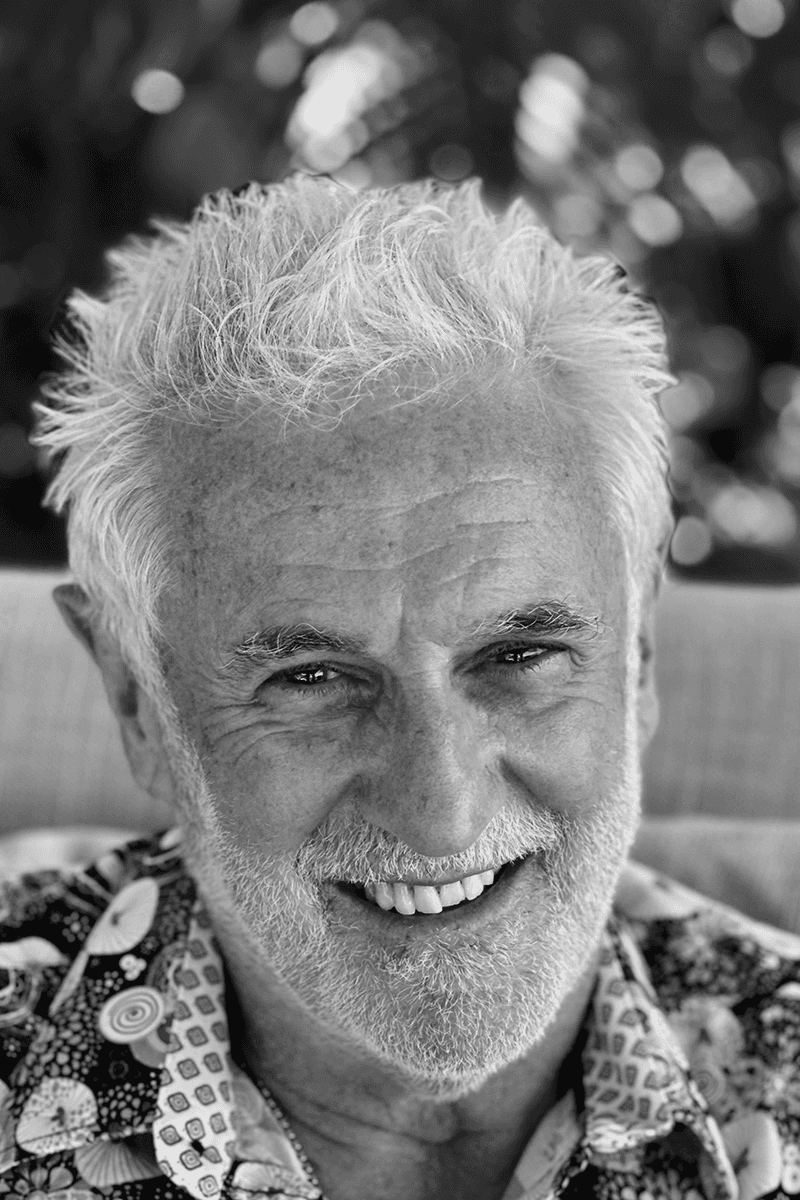 Portrait of Kevin Whitley, Founder + CEO of KWA Design, smiling in patterned shirt