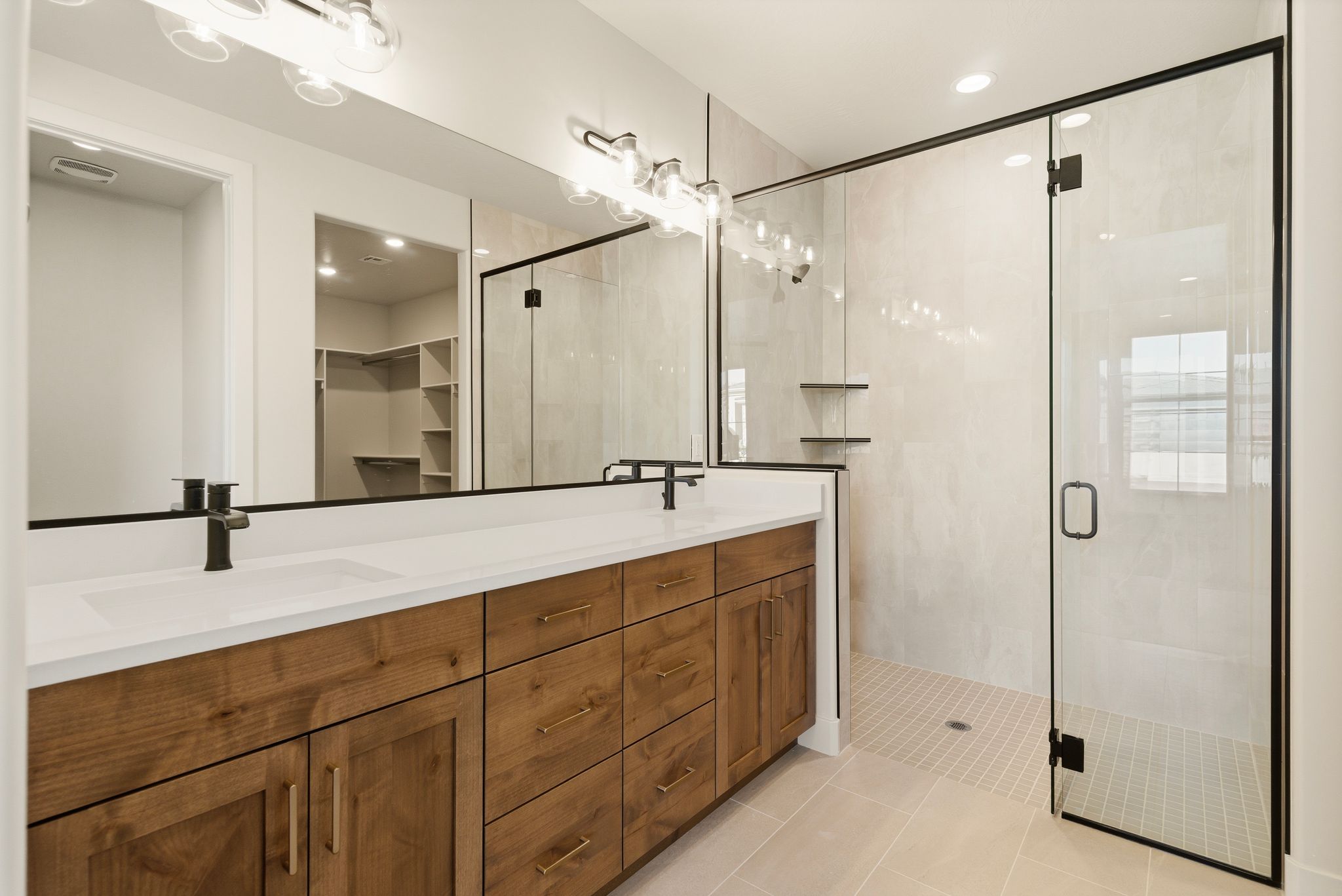 Master bathroom in The View at Falcon Ridge, Hurricane, Utah, showcasing a walk-in shower, dual vanities, and luxury details.
