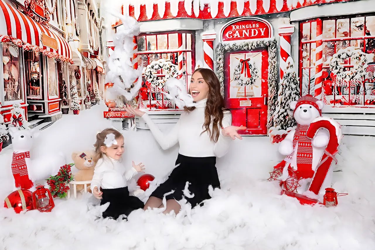A mother and daughter happily posing with feathers taken for their Christmas photos, captured by Mahvin Photography in Dubai.