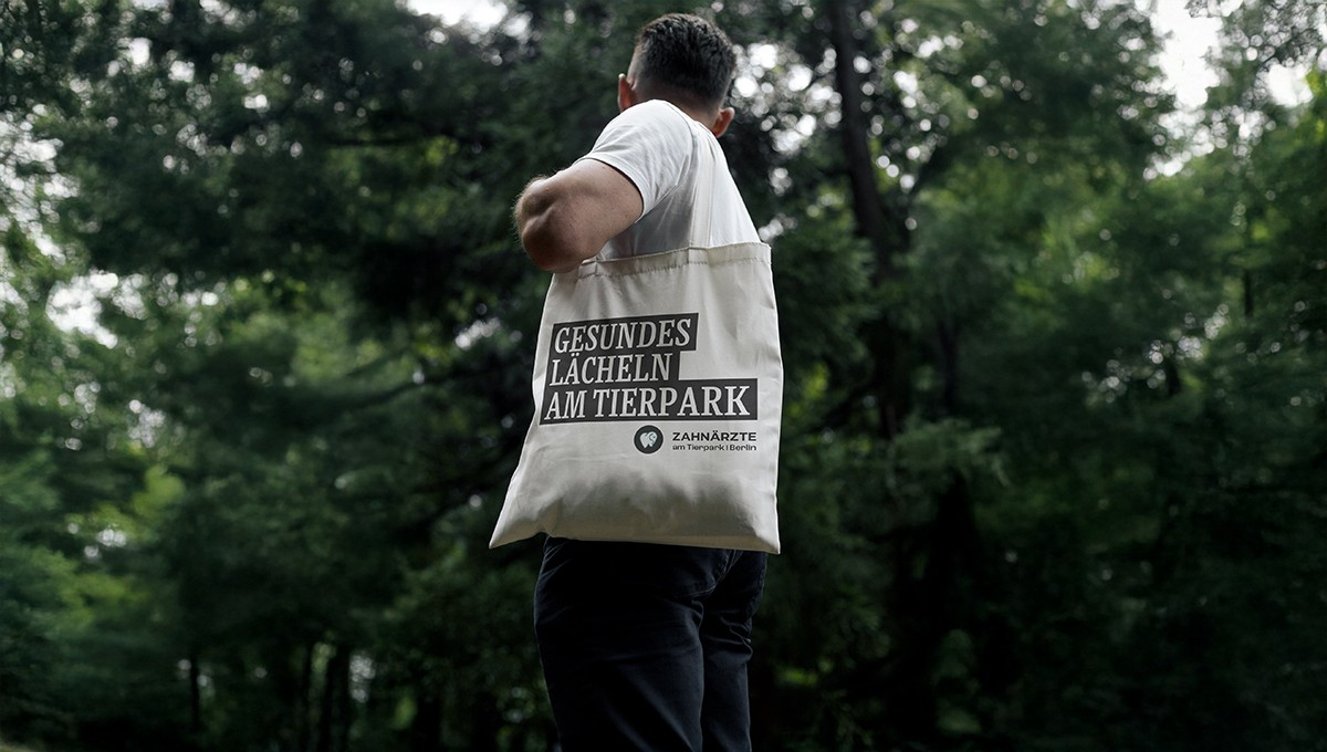 Family standing in a lush green field with tractor.