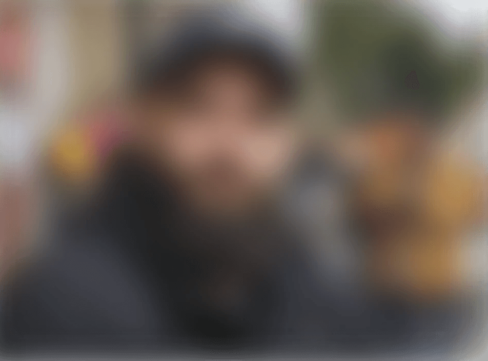 A man with a beard and a baseball cap