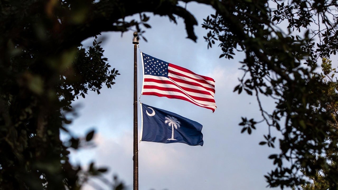 five children smiling while doing peace hand sign