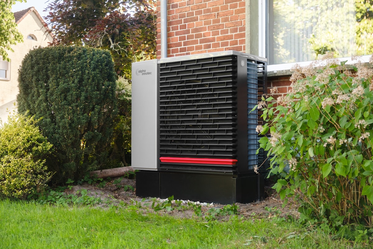 Residential heat pump unit installed beside a home, replacing gas heating