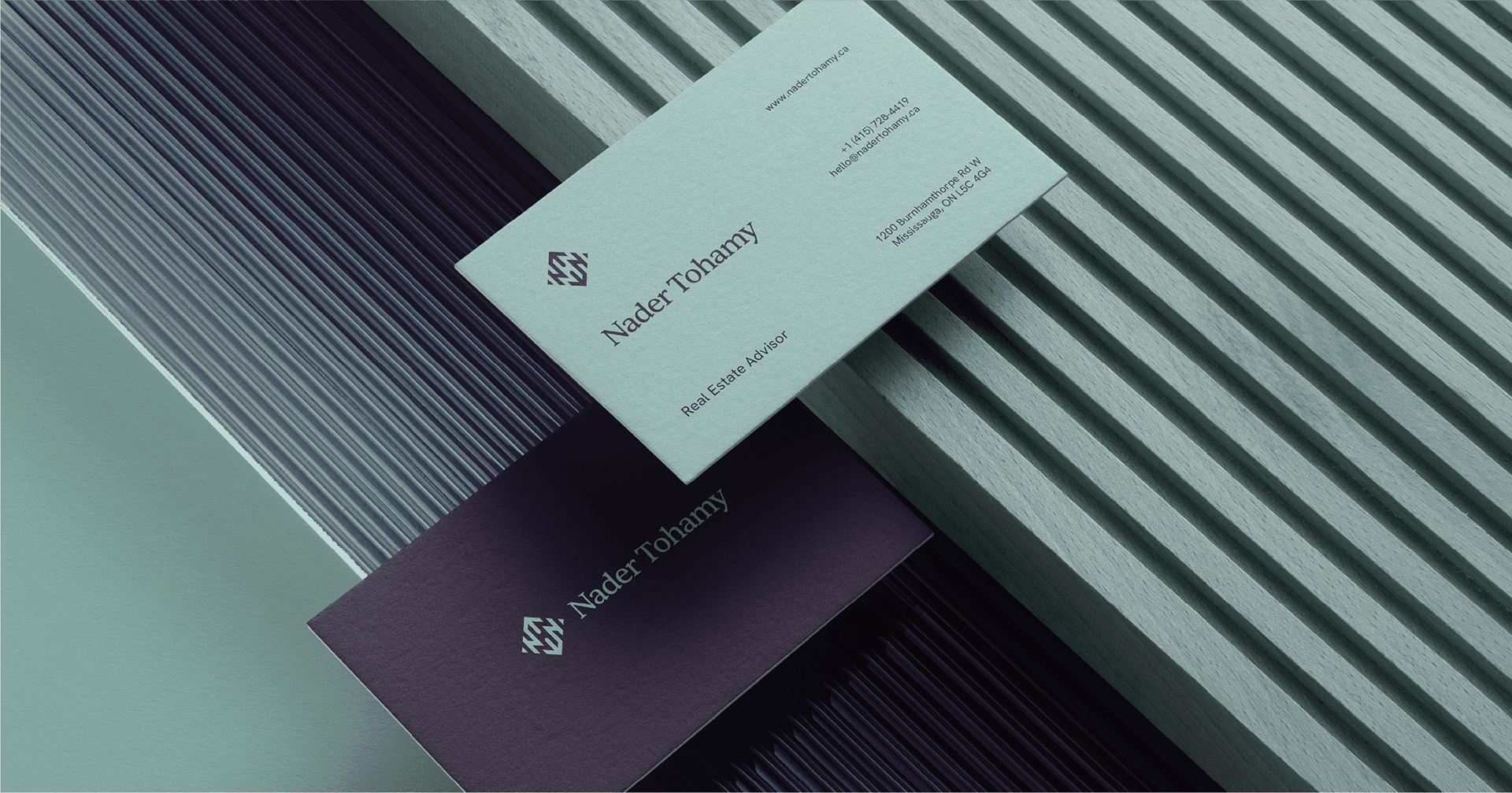 Nader Tohamy business card mockup in sage green and dark purple on a ribbed surface.
