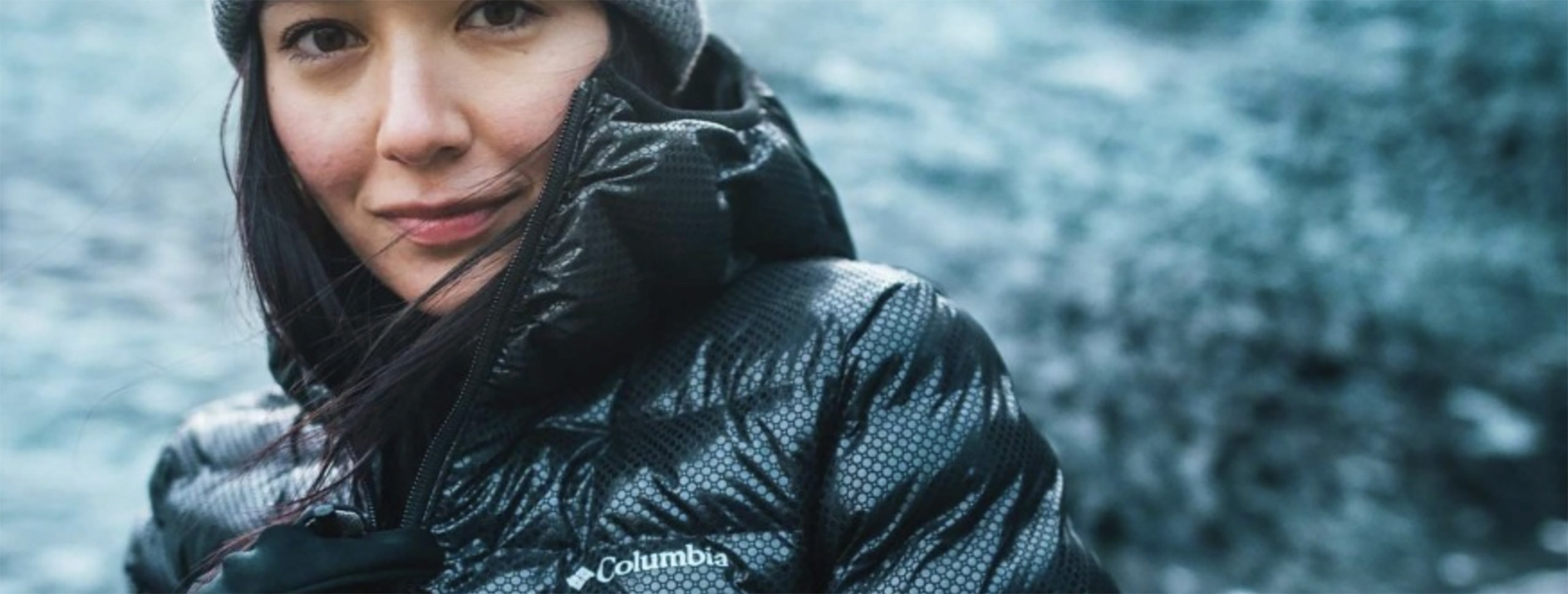 Person wearing a Columbia jacket in a cold, outdoor landscape, representing exploration, resilience, and performance.