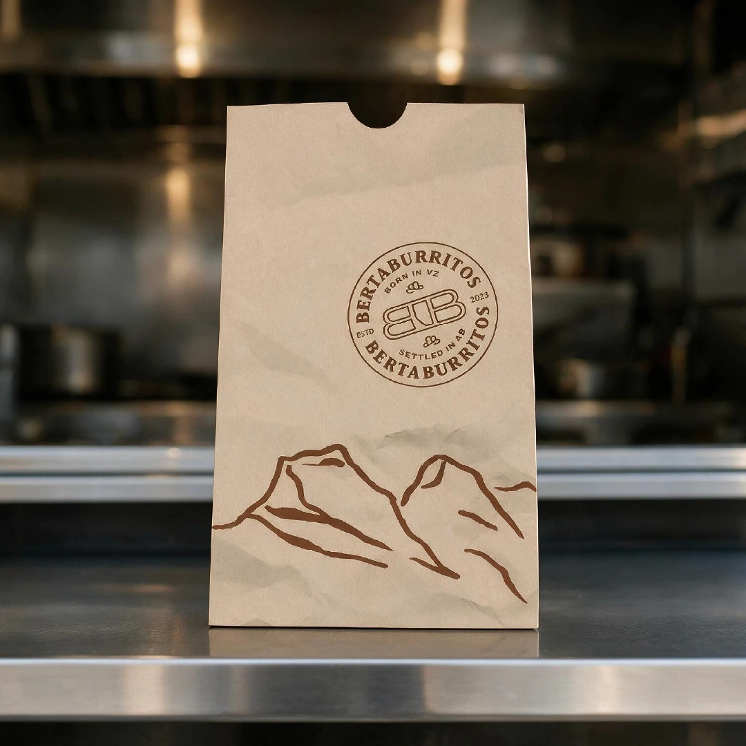 BertaBurritos branded takeout bag featuring the restaurant logo and Alberta-inspired mountain illustration