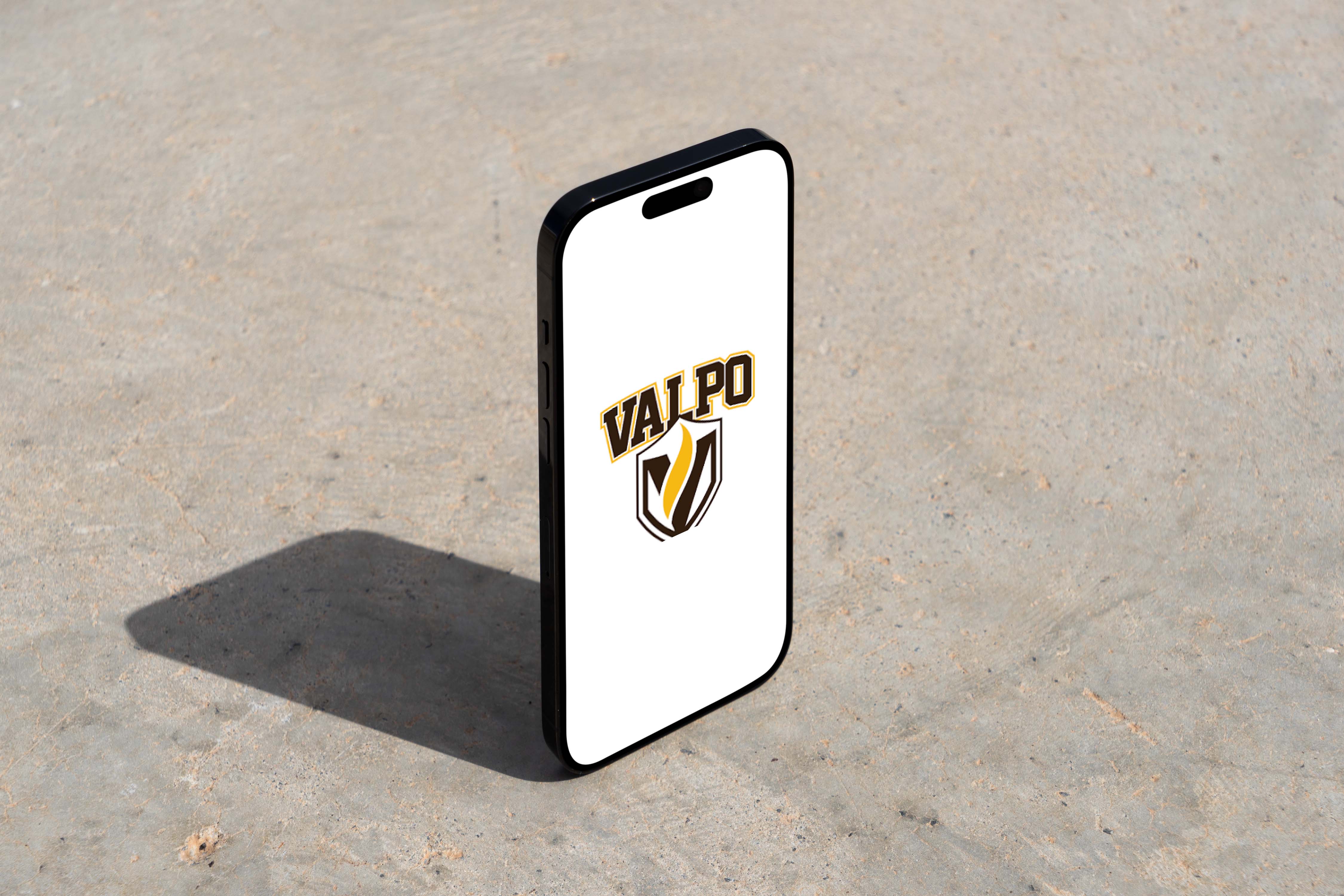 A modern smartphone displaying a logo stands upright on a textured concrete surface, casting a clear shadow, perfect for showcasing UI design and mobile design concepts.