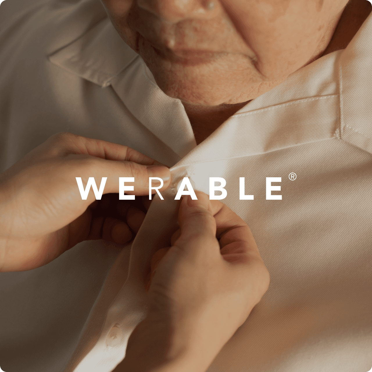 A caregiver dressing an elderly person, featuring the Werable logo