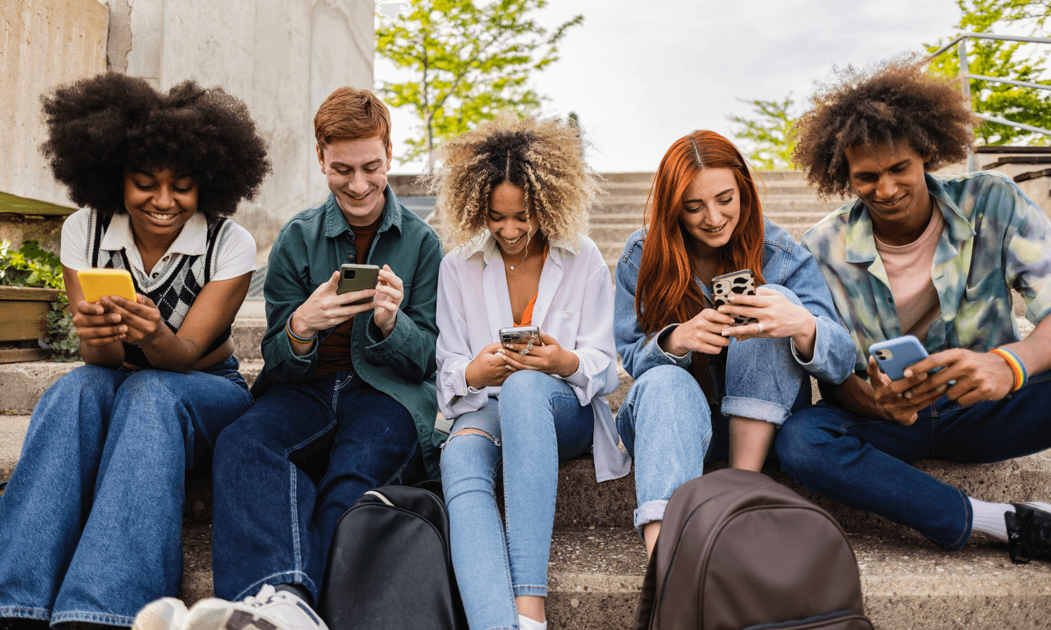 Teenagers on their phones looking at social media