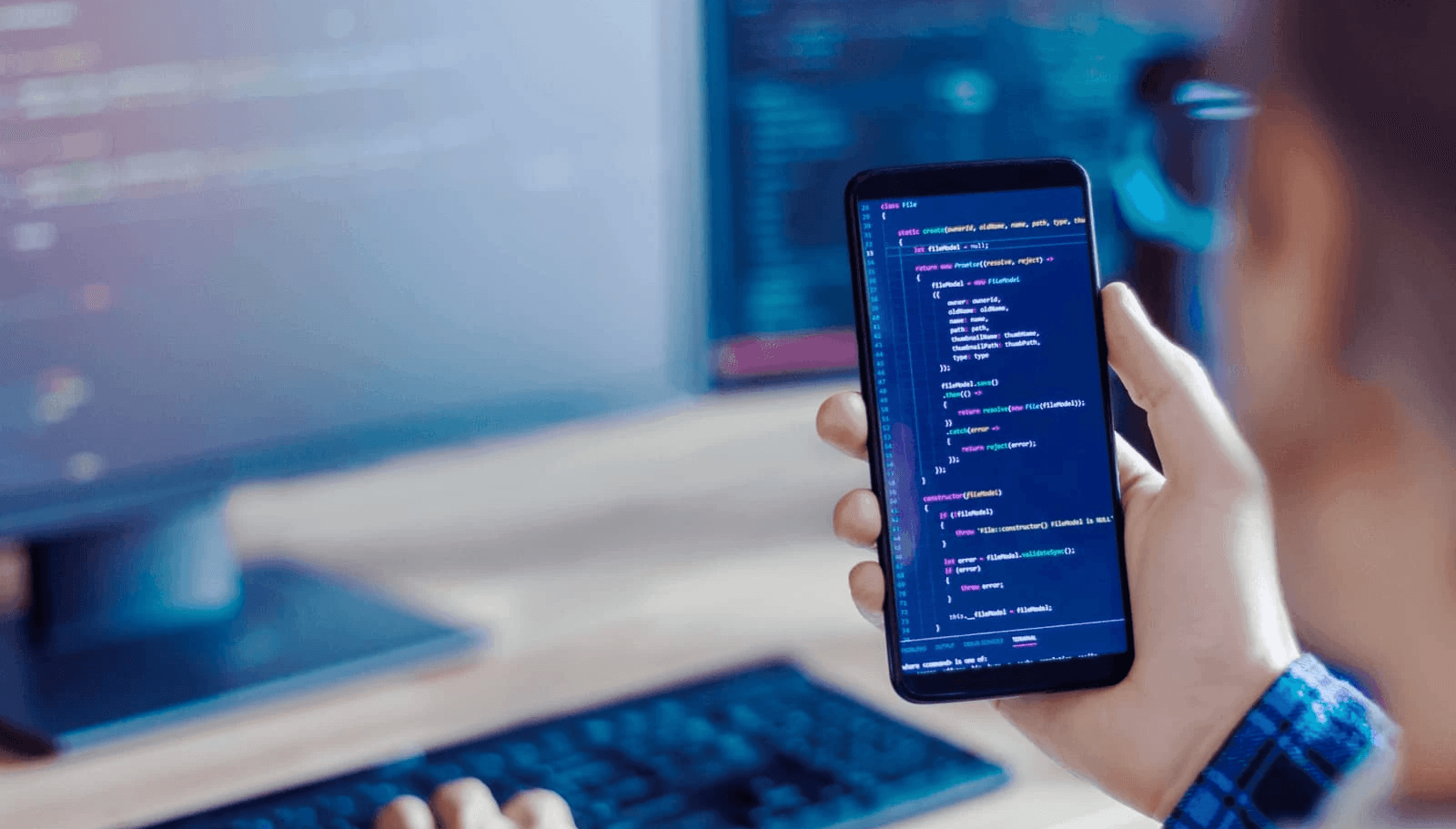 Man testing code across multiple screens - Best Place to Hire Mobile App Developers