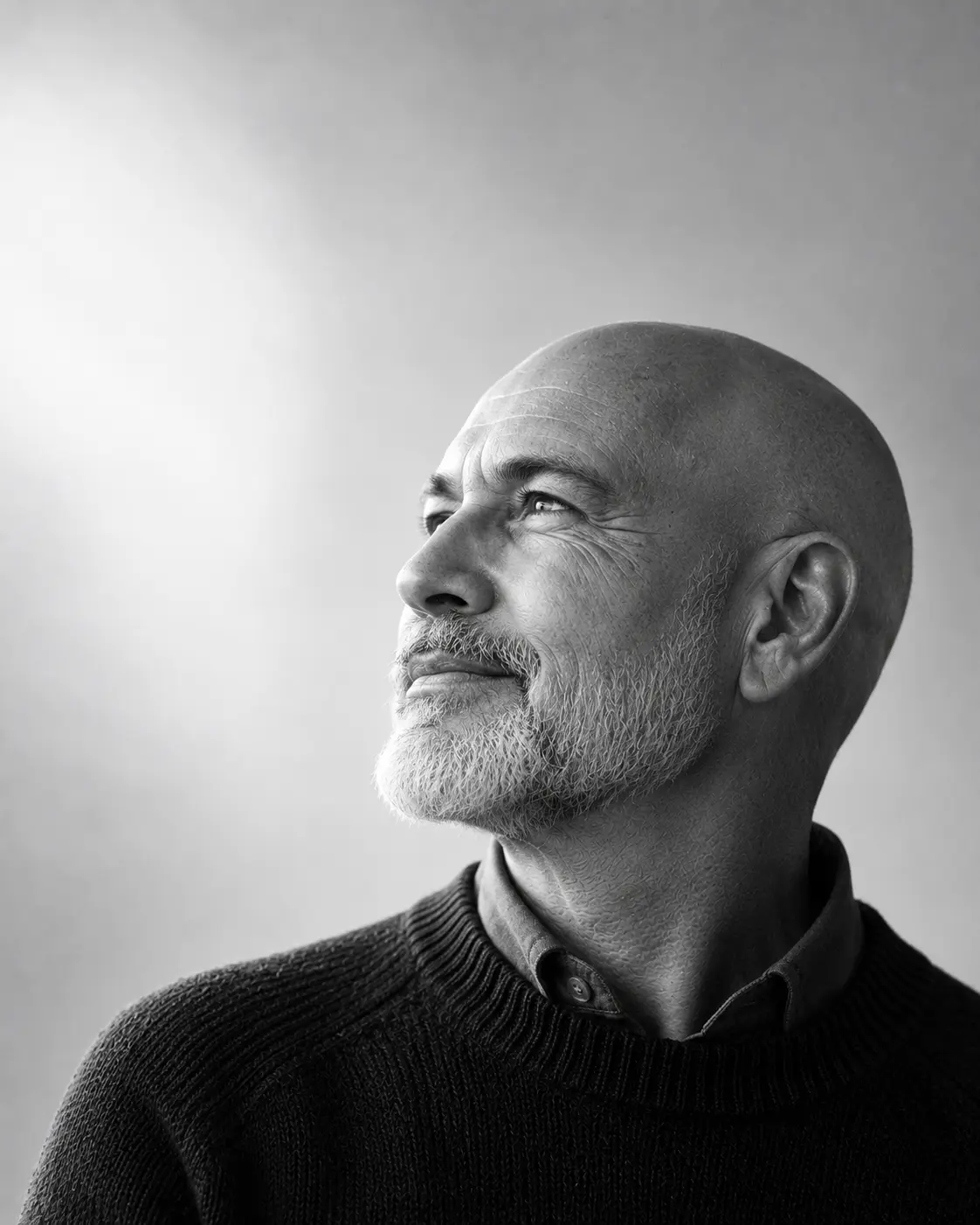 Gideon Falk, senior advisor, with a shaved head and short white beard, looking up and to the left
