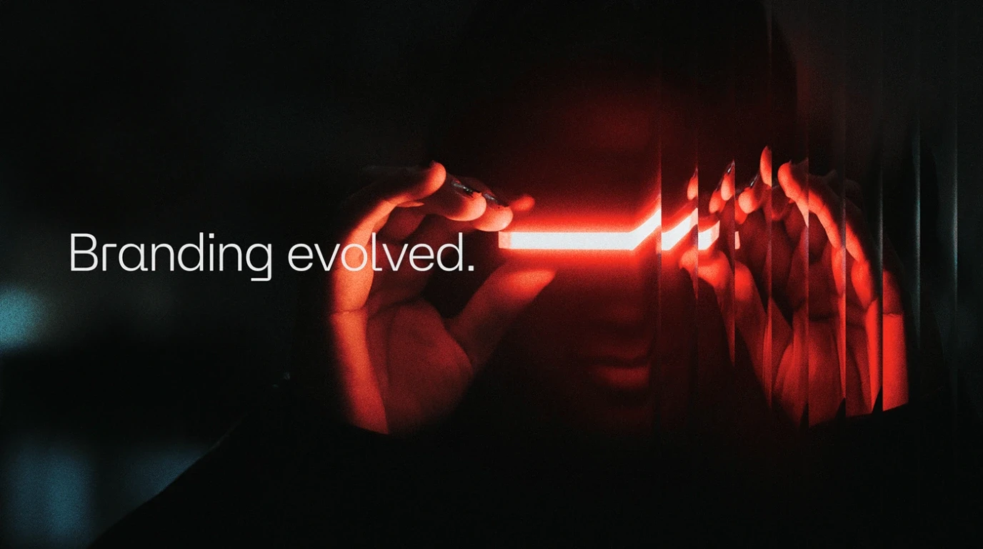A person wearing futuristic glowing red smart glasses in a dark environment.