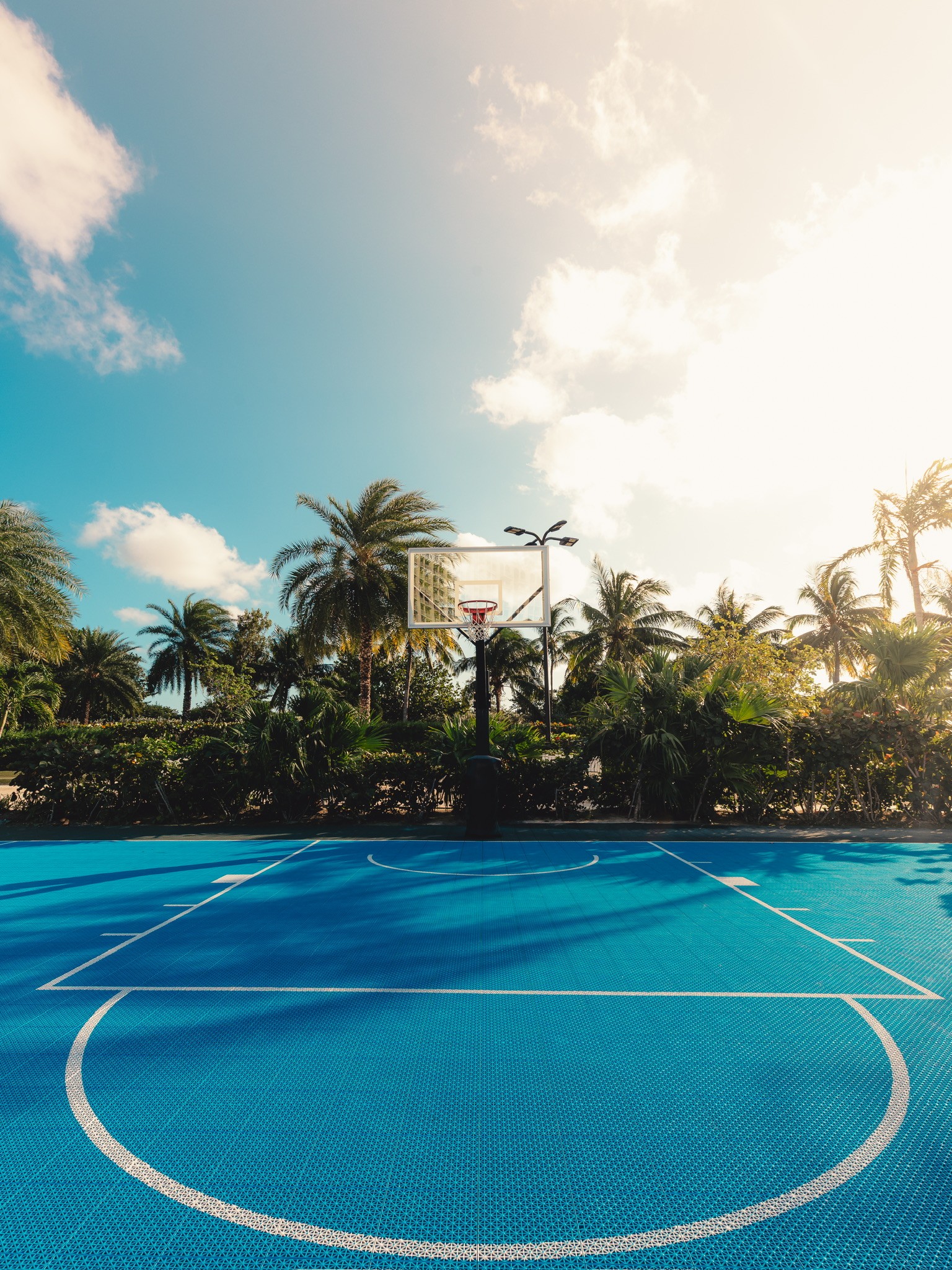 Three people sitting on a couch in a room looking at mobile devices