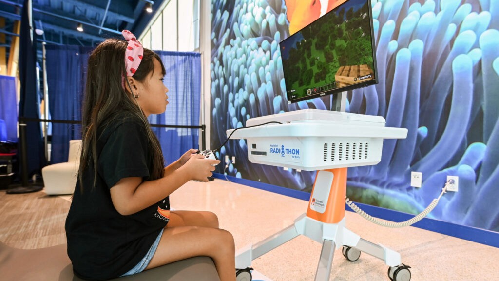 Patient at Kapiolani Medical Center in Haiwaii playing Minecraft on a GO Kart.