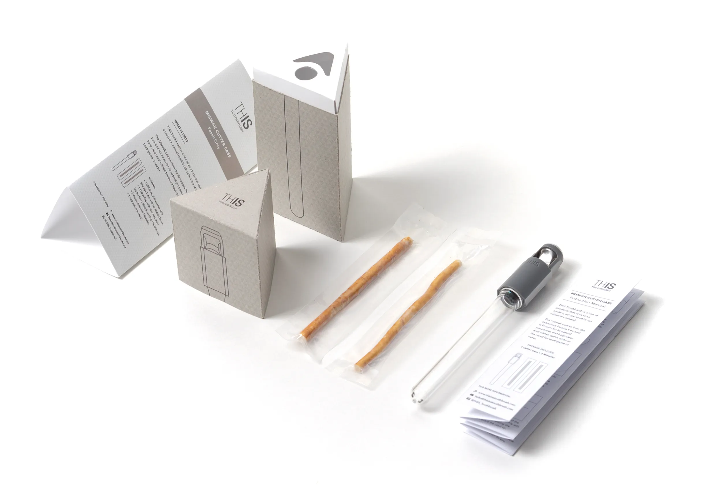THIS toothbrush packaging components, toothbrush parts, and printed materials arranged on white