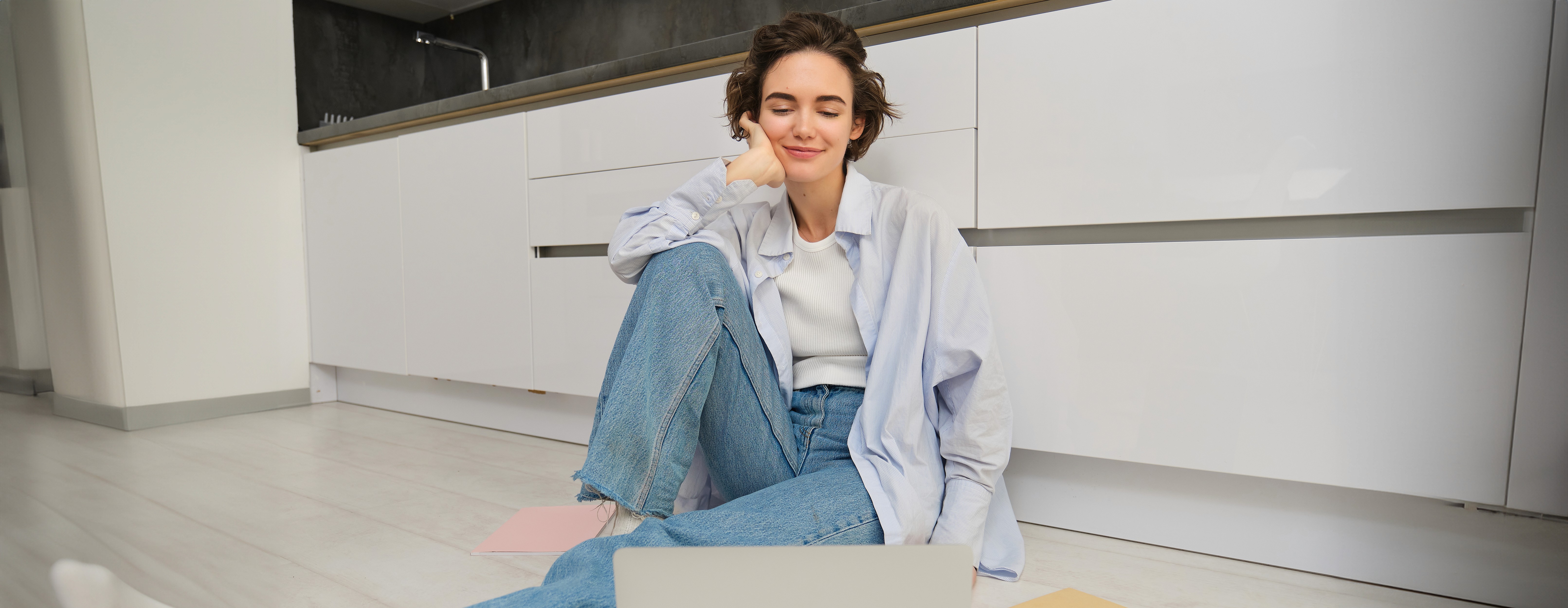 Woman in pink loungewear sitting in the patio.