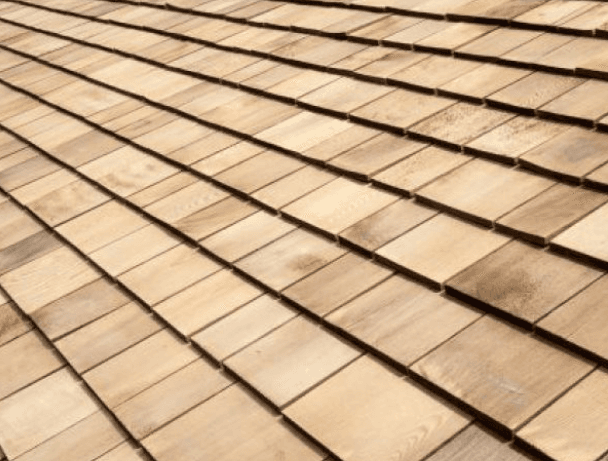 a man in a yellow shirt is working on a roof