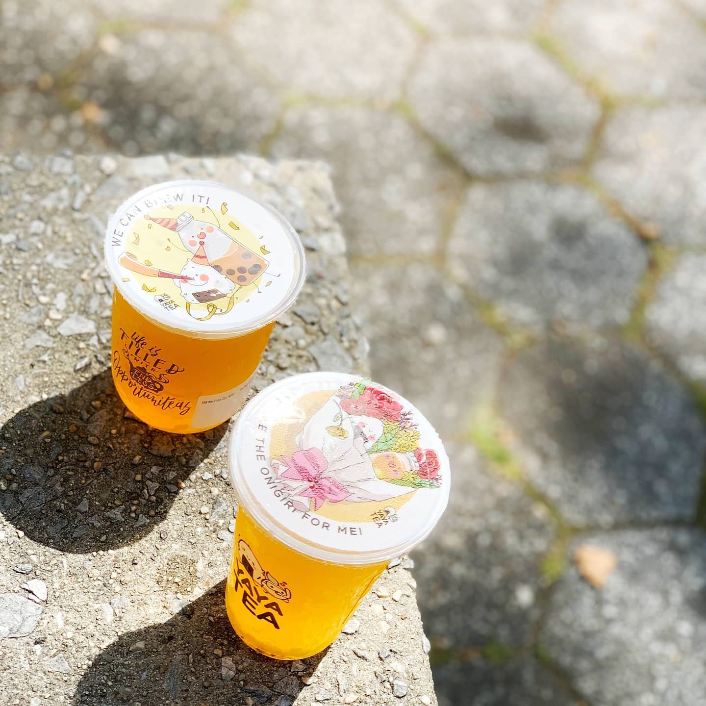 A vibrant shot of Yaya Tea’s Boyfriend Drink, a refreshing mango-lychee white tea, served in a clear cup with a colorful straw, showcasing its fresh and fruity appeal.