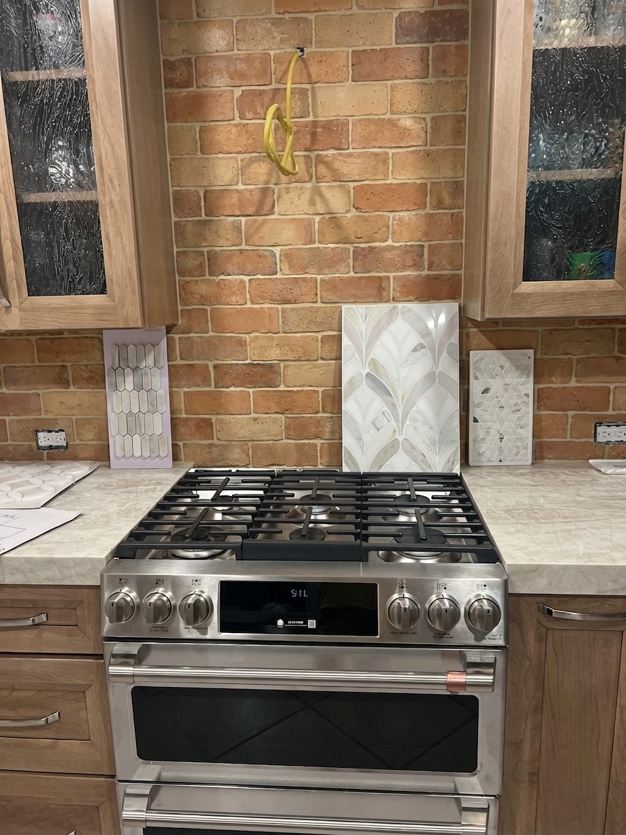 Warm terracotta tile backsplash bringing Mediterranean warmth to the kitchen