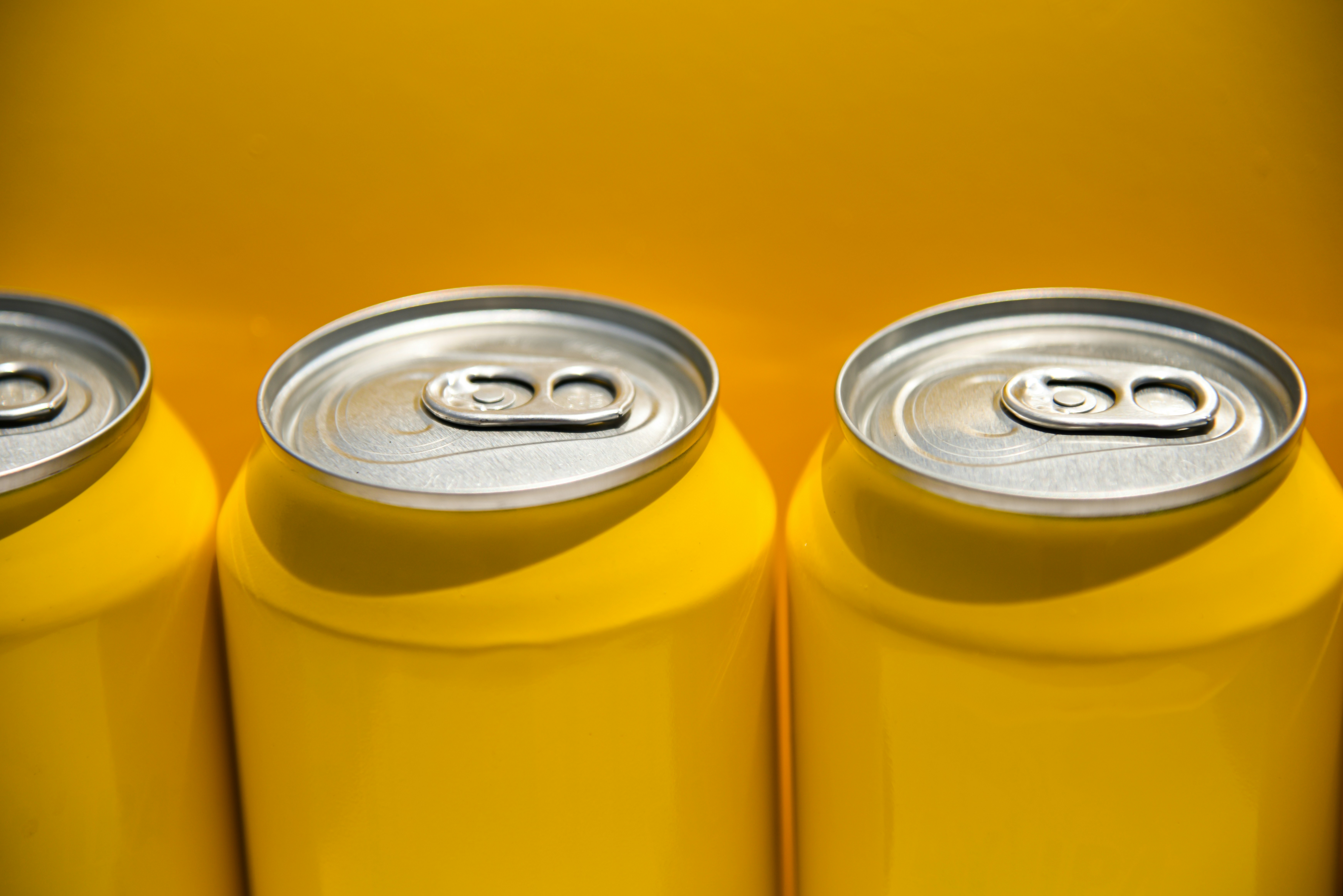 3 yellow drink cans