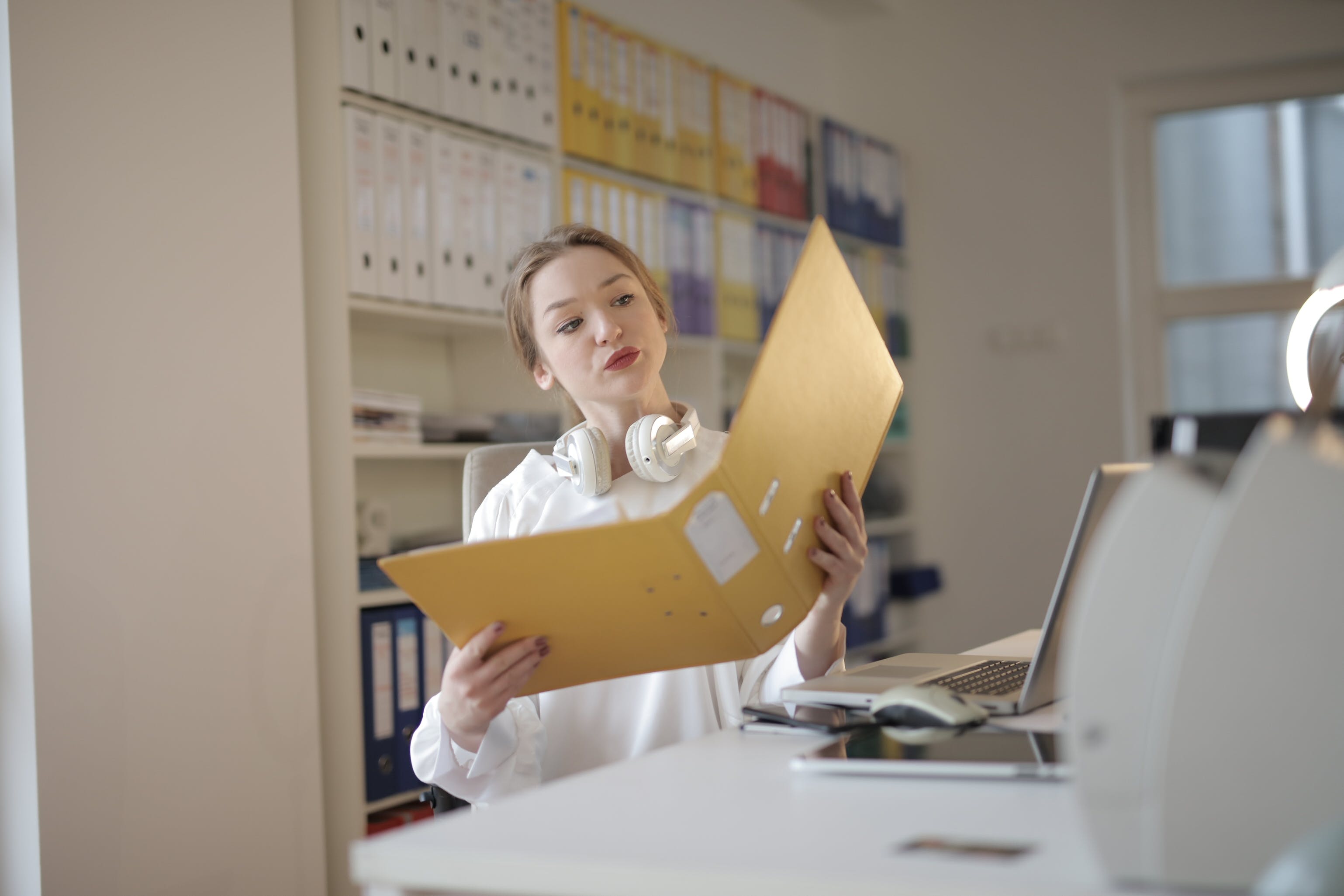 Female office worker with folder thinking about remortgaging without a broker