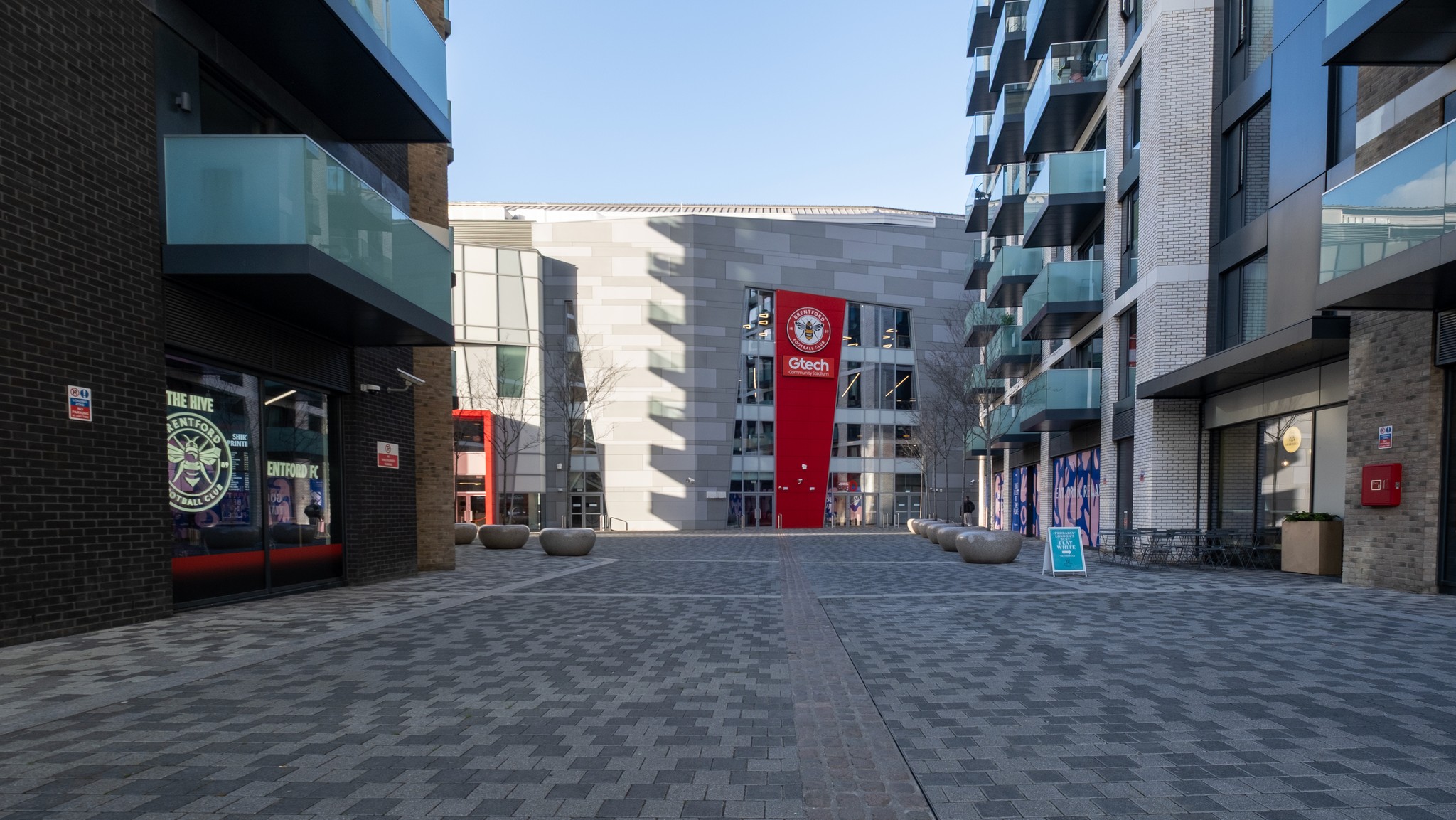 Two classic volkswagen beetles, one green, one cream.