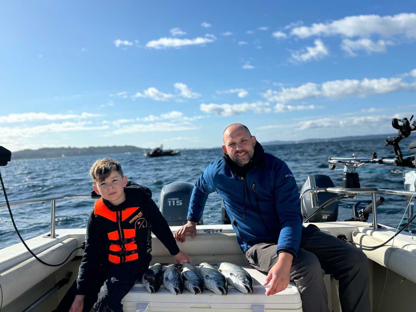 Dad and son showing freshly caught salmon