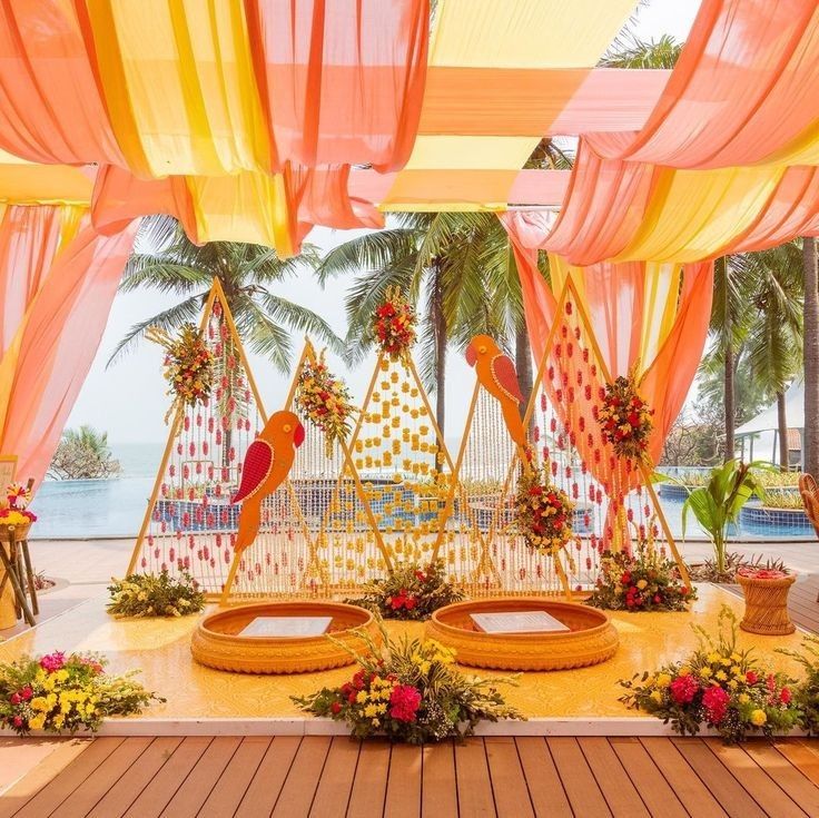 Haldi decoration on garden & terrace with colorful drapes, parrot-themed decor & flowers in Indirapuram, Dwarka & Janakpuri