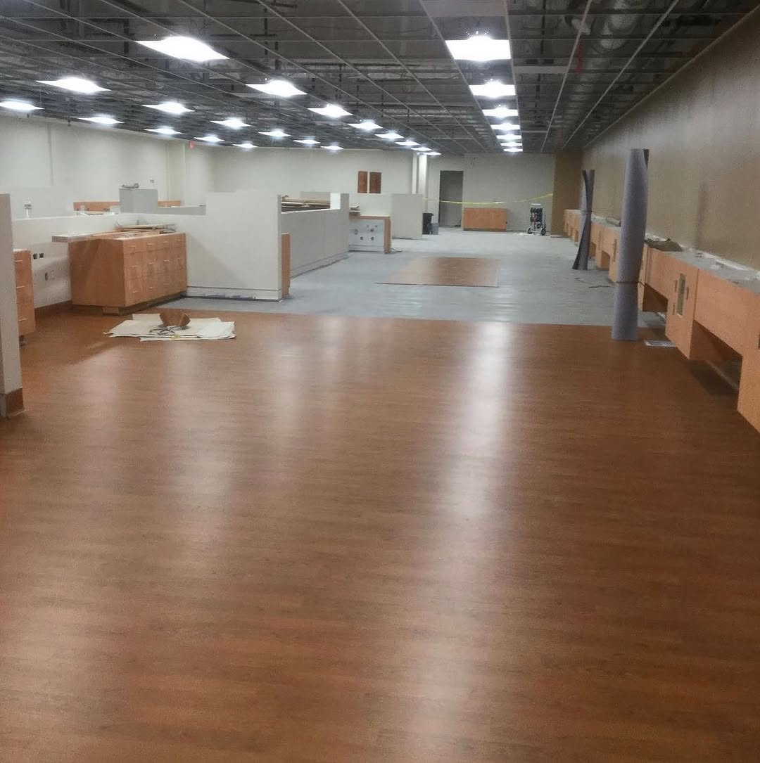 Completed clinic floor in wood-look sheet vinyl seen down the room