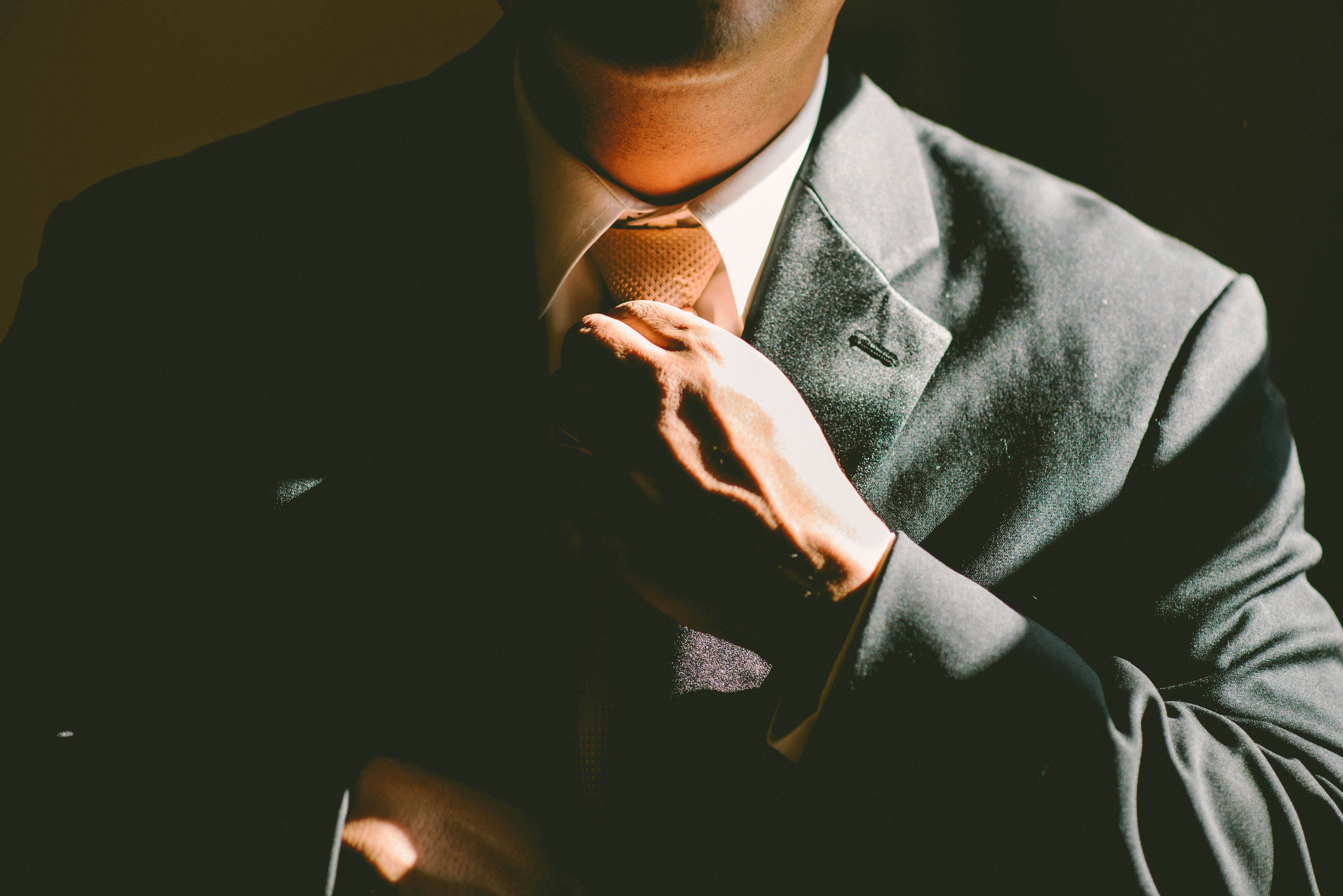 A Person adjusting his Tie