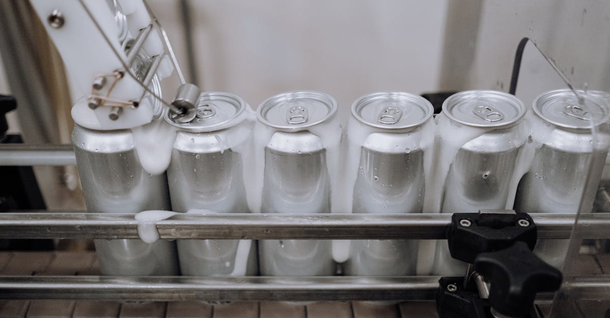 Close-up of aluminum cans on an assembly line in a modern brewery showing automation and machinery a