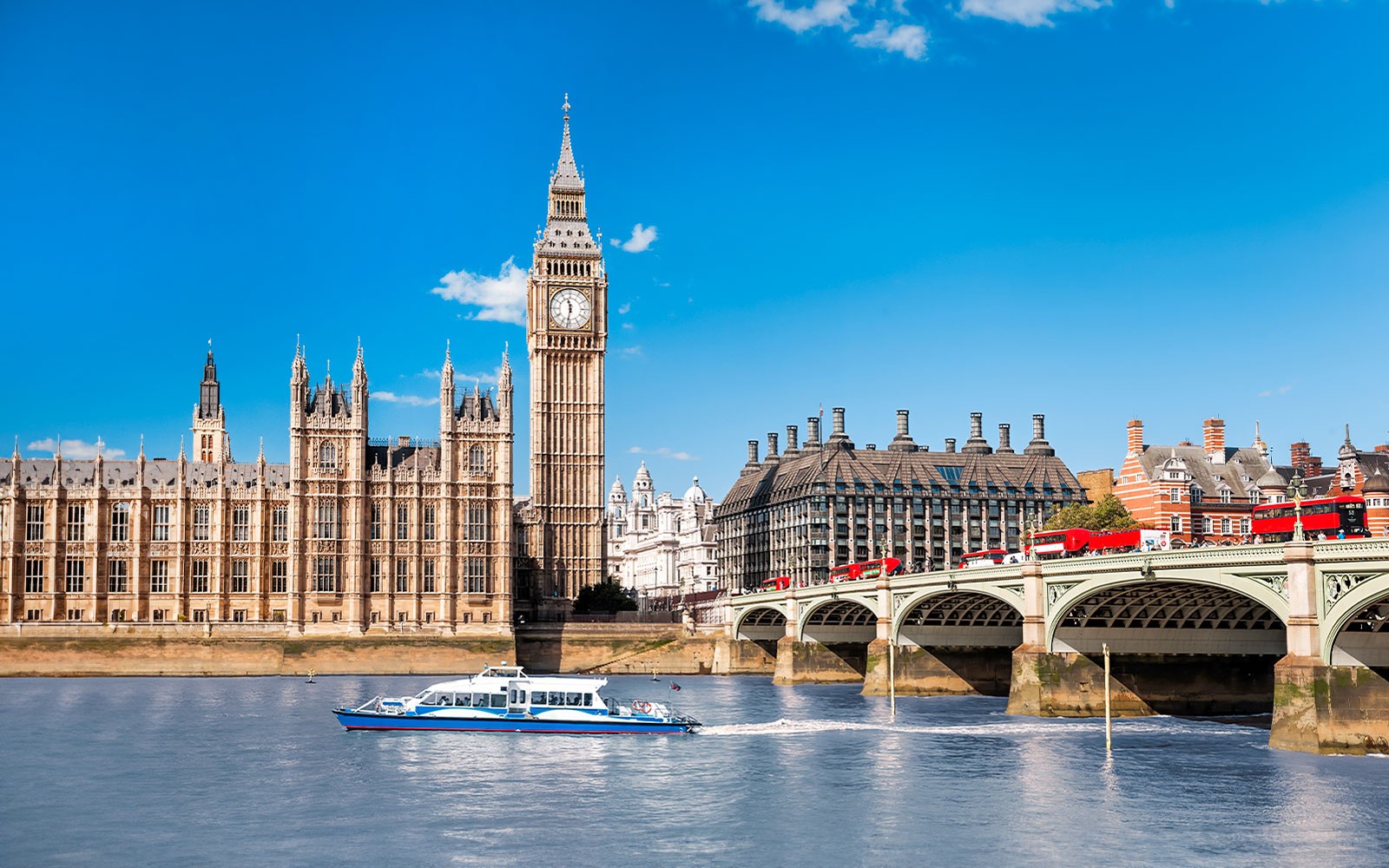 Thames River cruise boat near Big Ben and Westminster Bridge on River Red Rover tour.