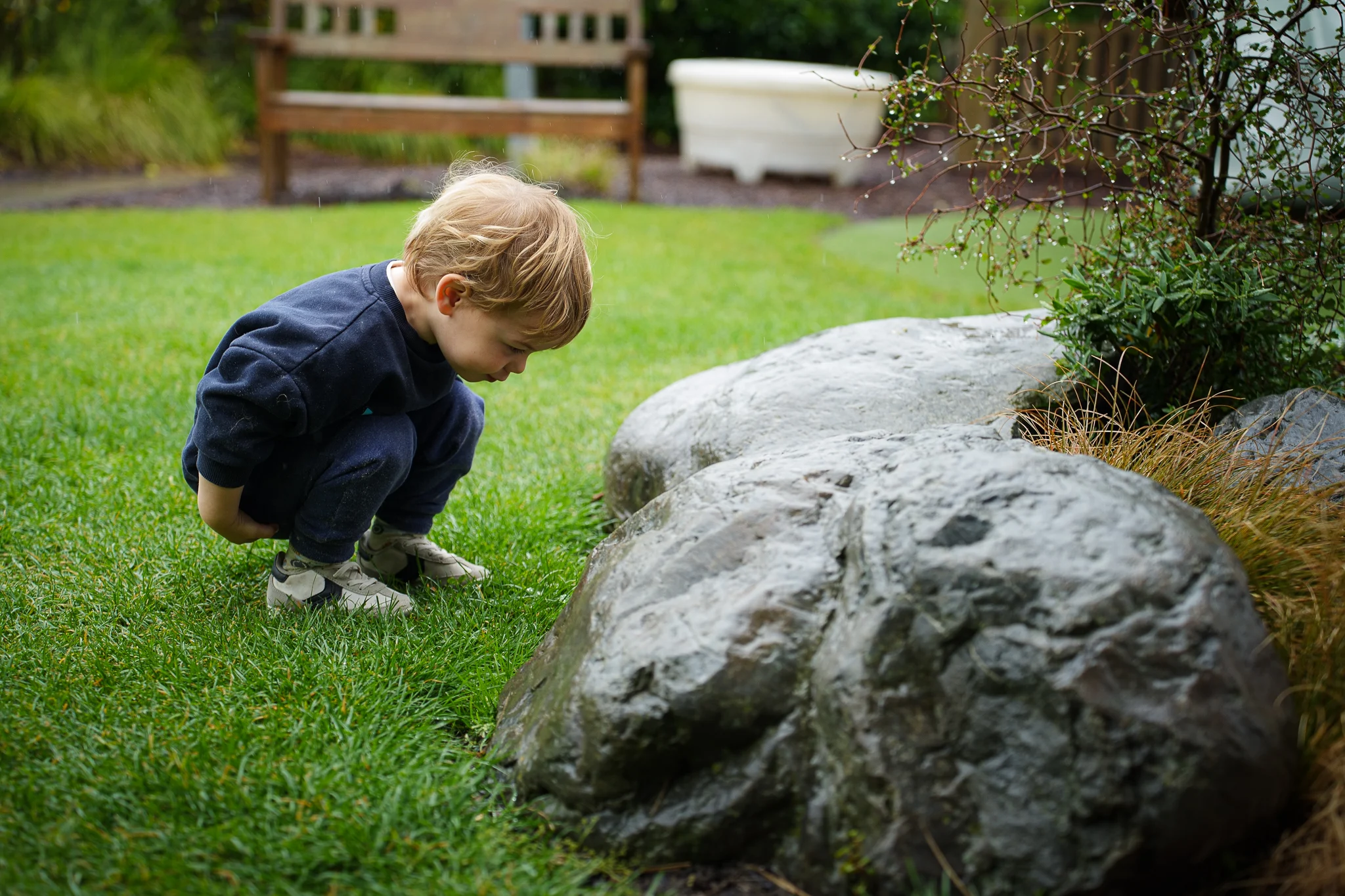 A young child exploring the outdoor environment during playtime.